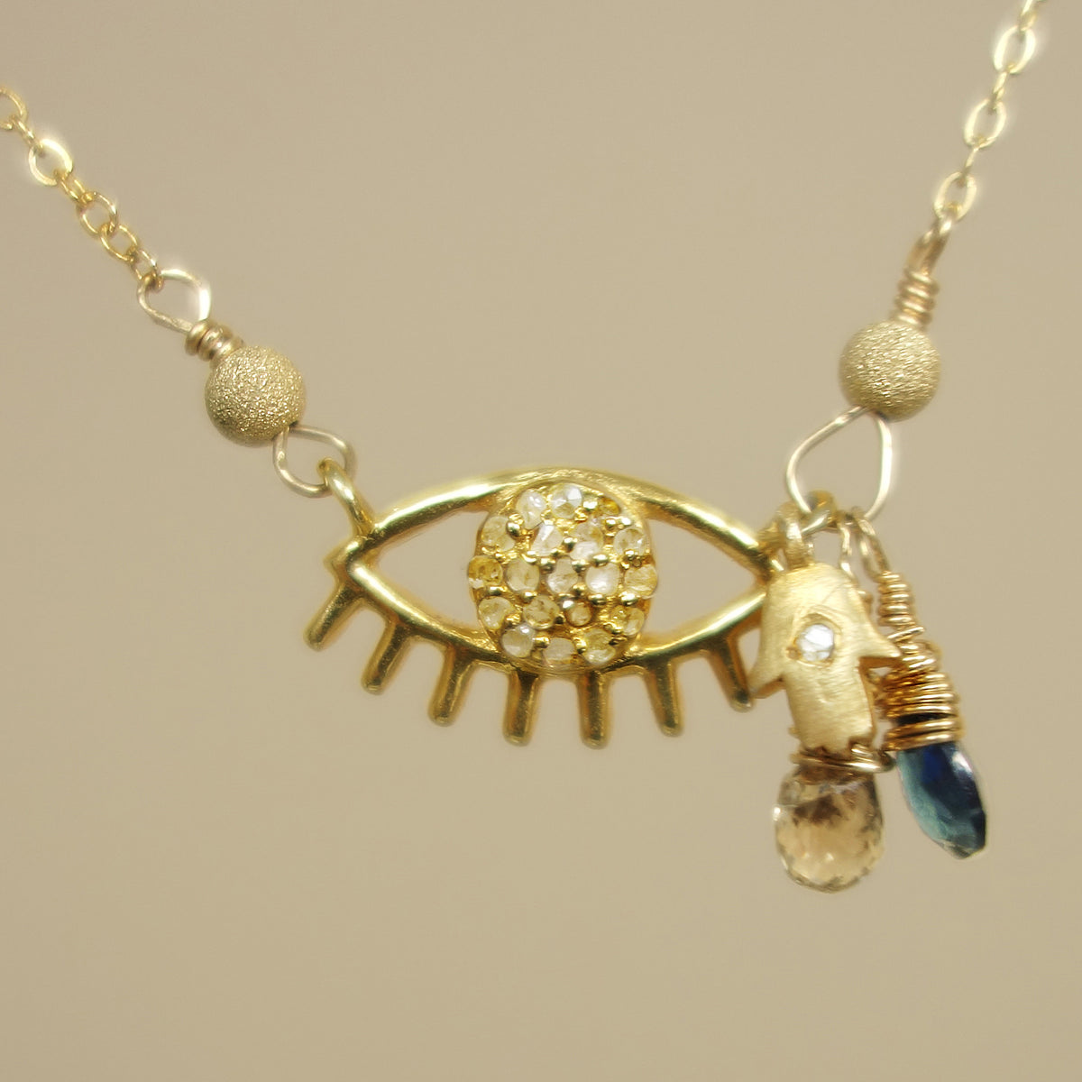 Protective Eye necklace: diamond and blue sapphire on gold