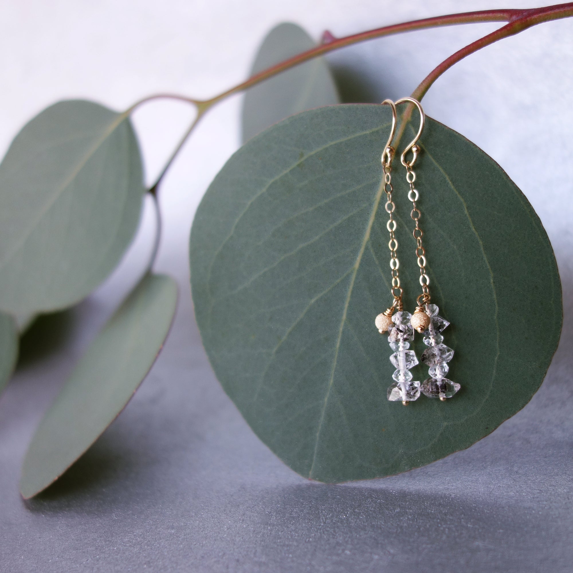 Rhudalated crystal quartz on chain ear in gold or silver