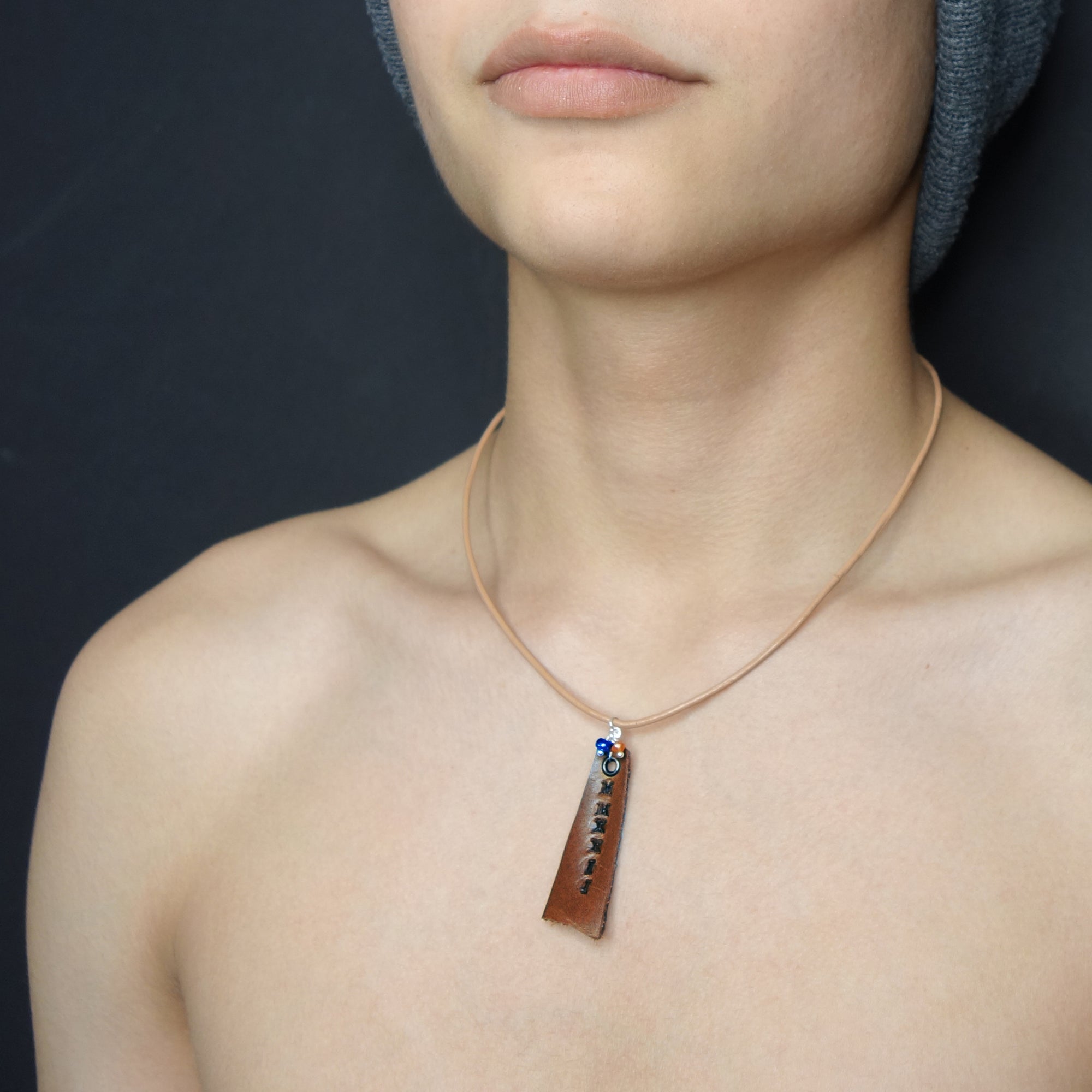 Leather stamped MMXXIV with school colors (gems)