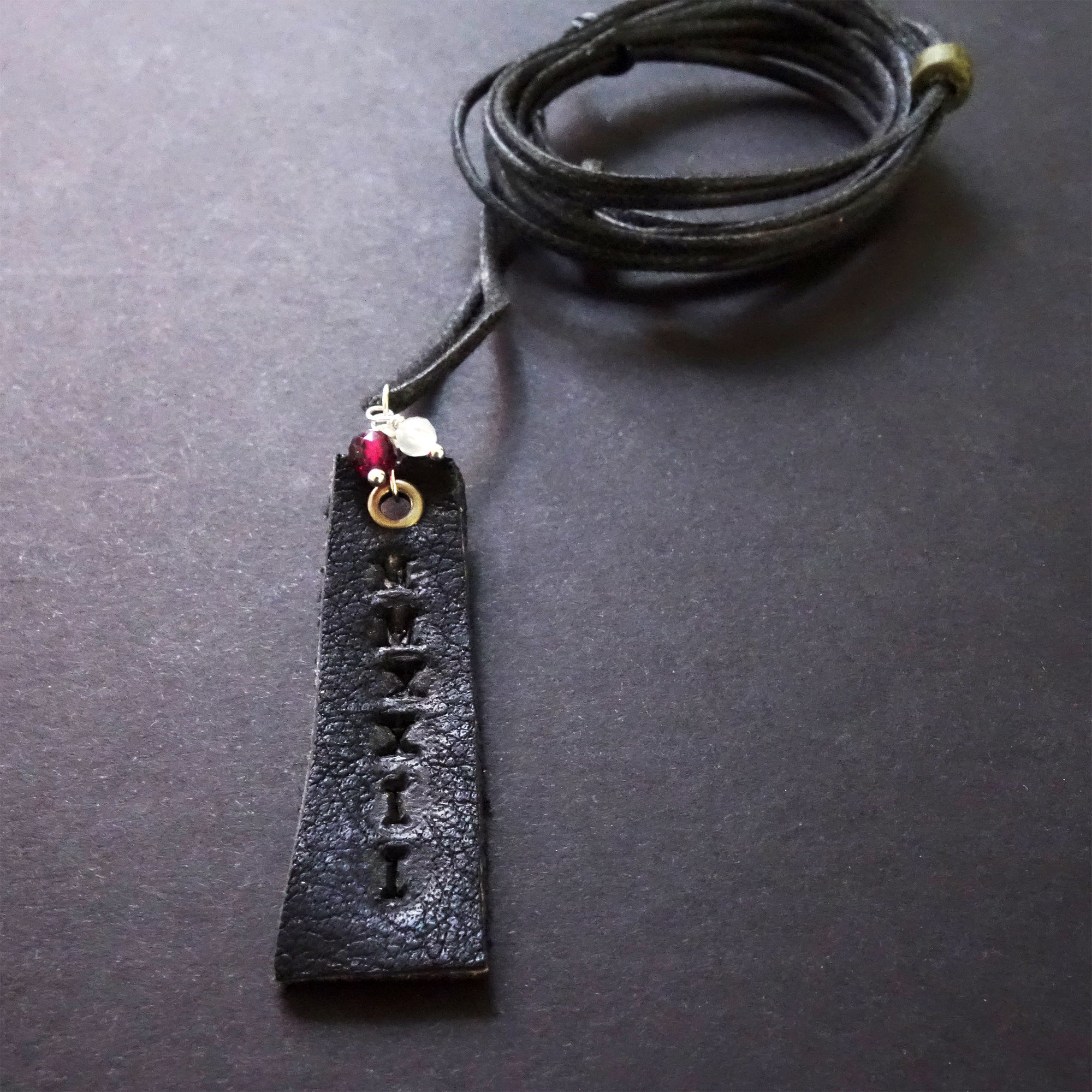 Leather stamped MMXXIV with school colors (gems)