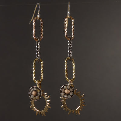 It's a New Dawn mosaic earring of gold, rose gold, and silver