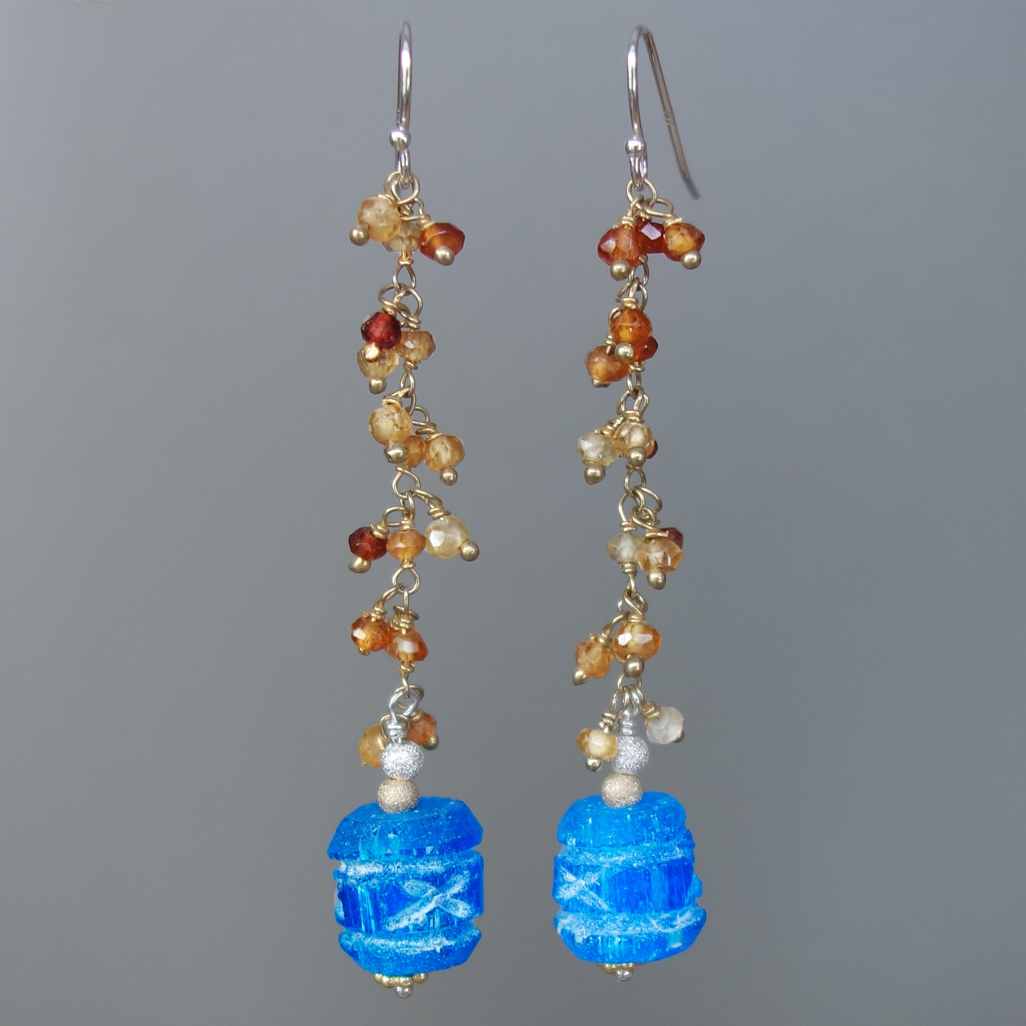 Carved apetite and hessonite garnet earring