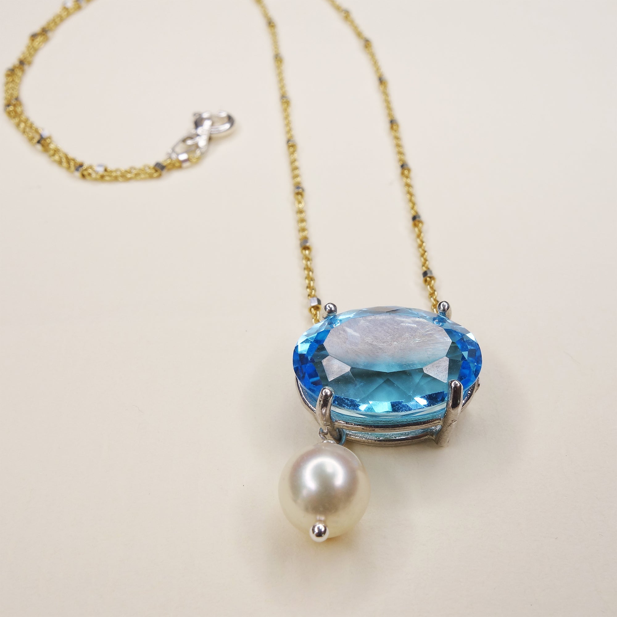 She Moves in Hues of Blues: Swiss topaz, pearl, and gold