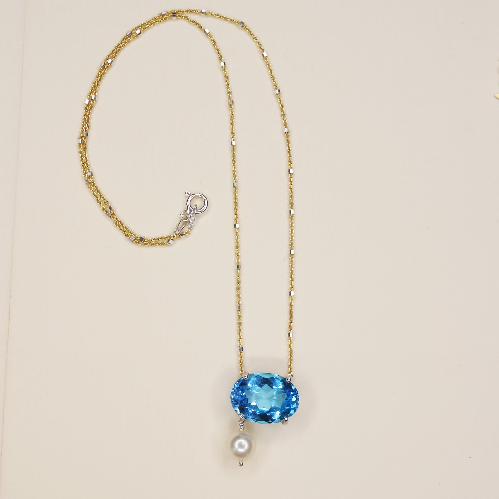 She Moves in Hues of Blues: Swiss topaz, pearl, and gold