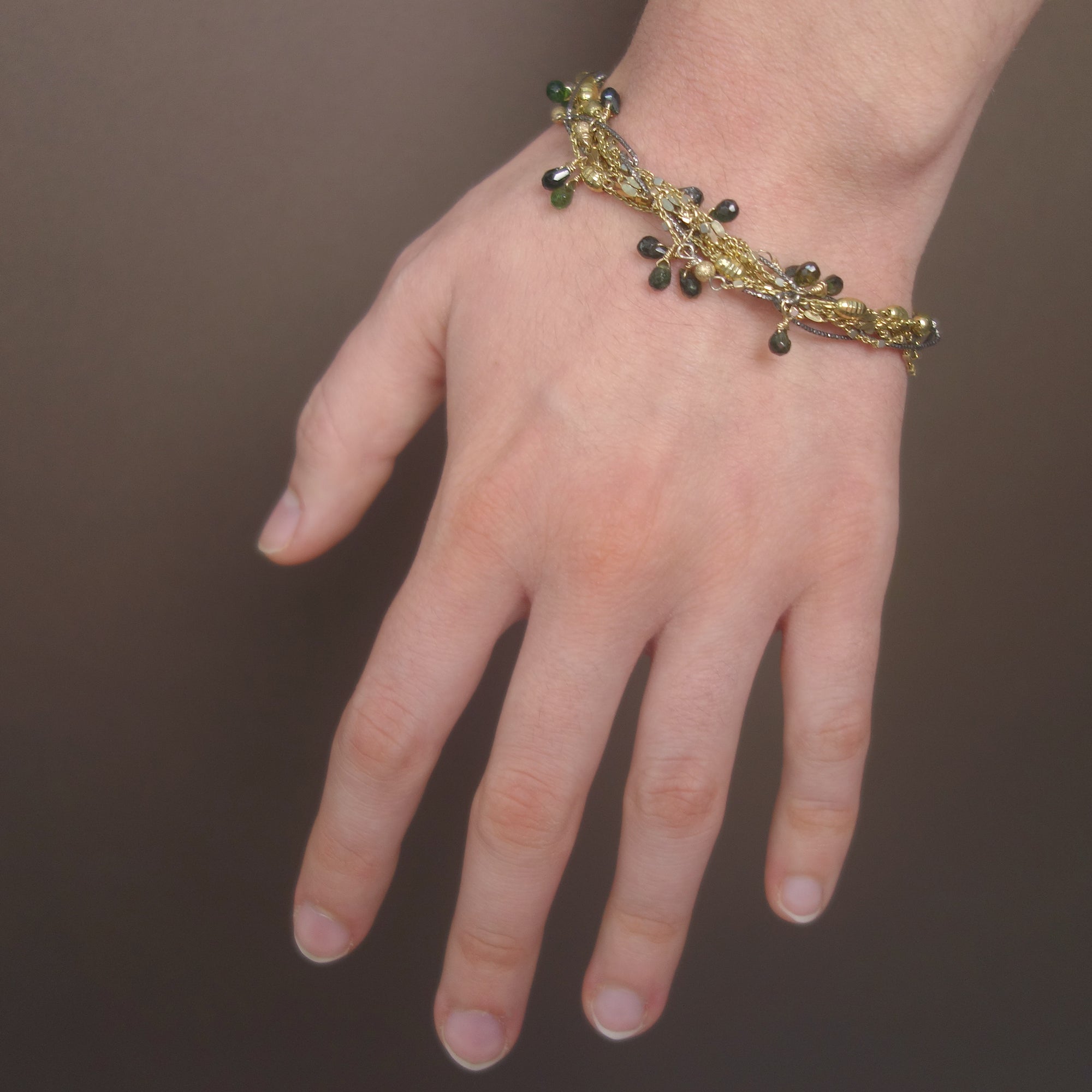 I've Seen Fire and Rain: emerald, gold, and silver bracelet
