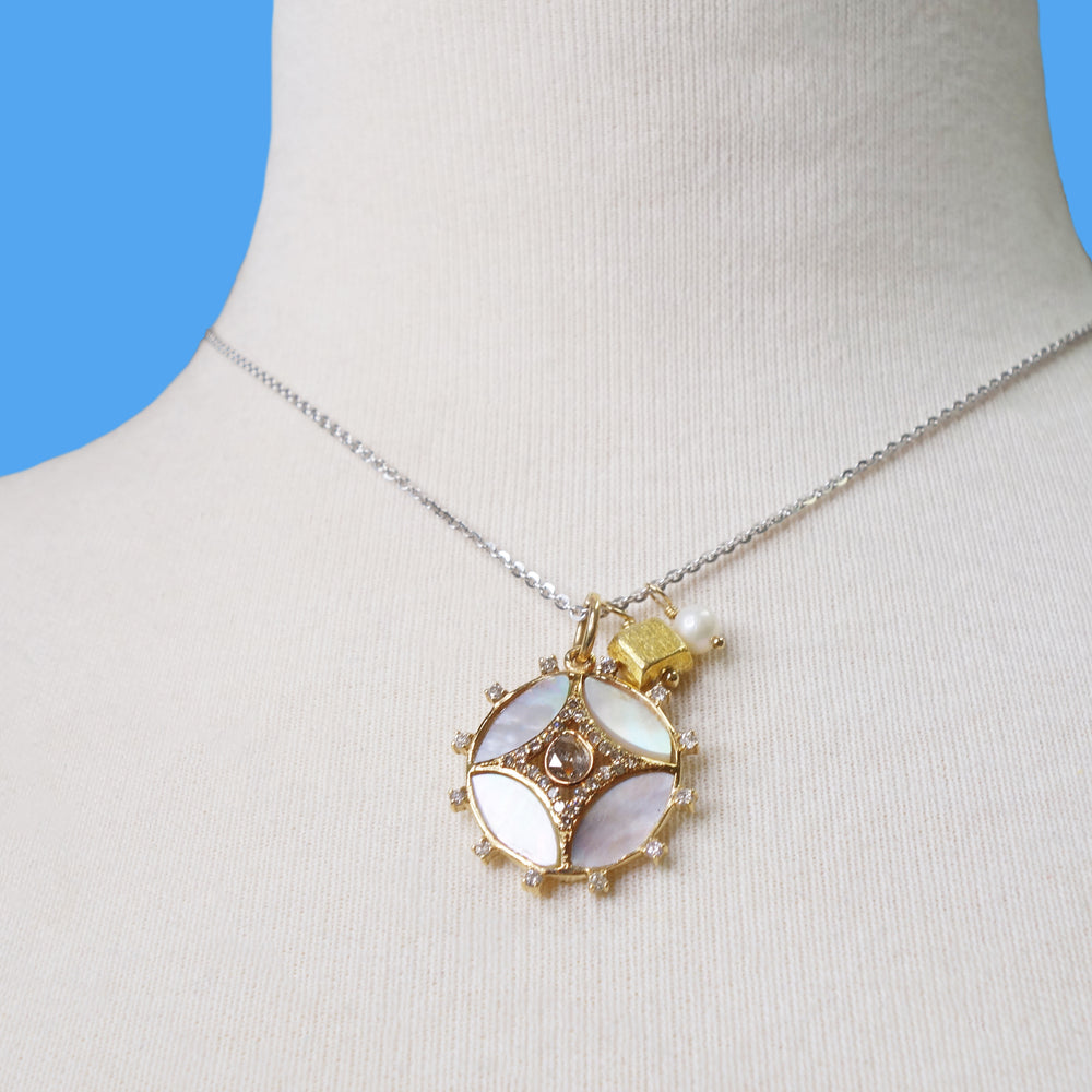 She Gleams: diamonds, mother of pearl in gold necklace