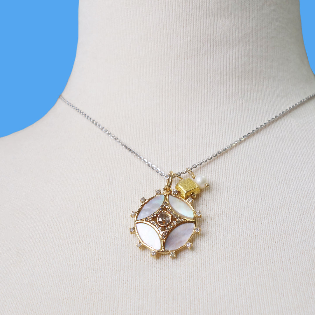 She Gleams: diamonds, mother of pearl in gold necklace