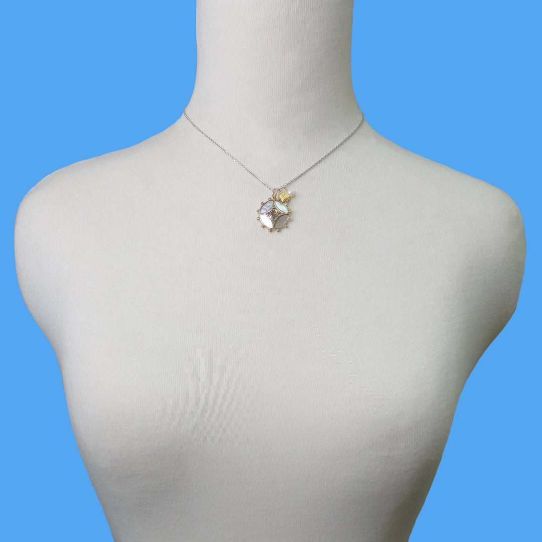 She Gleams: diamonds, mother of pearl in gold necklace