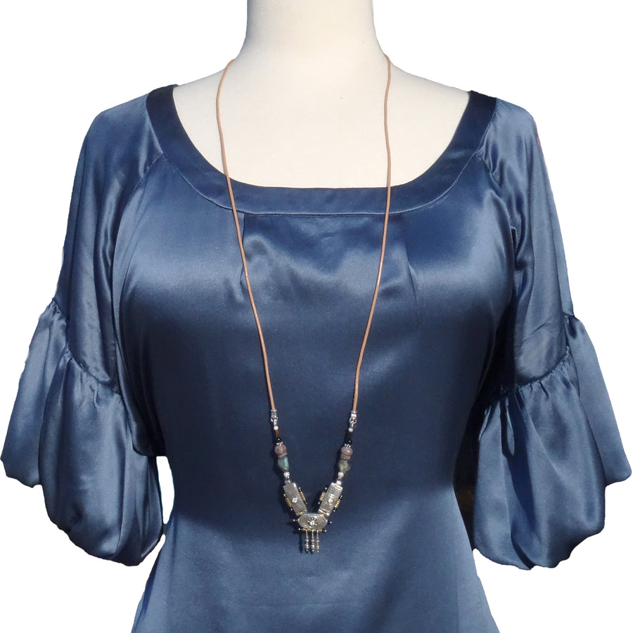 She Stood Her Ground: silver, gold, garnet, and white sapphire necklace