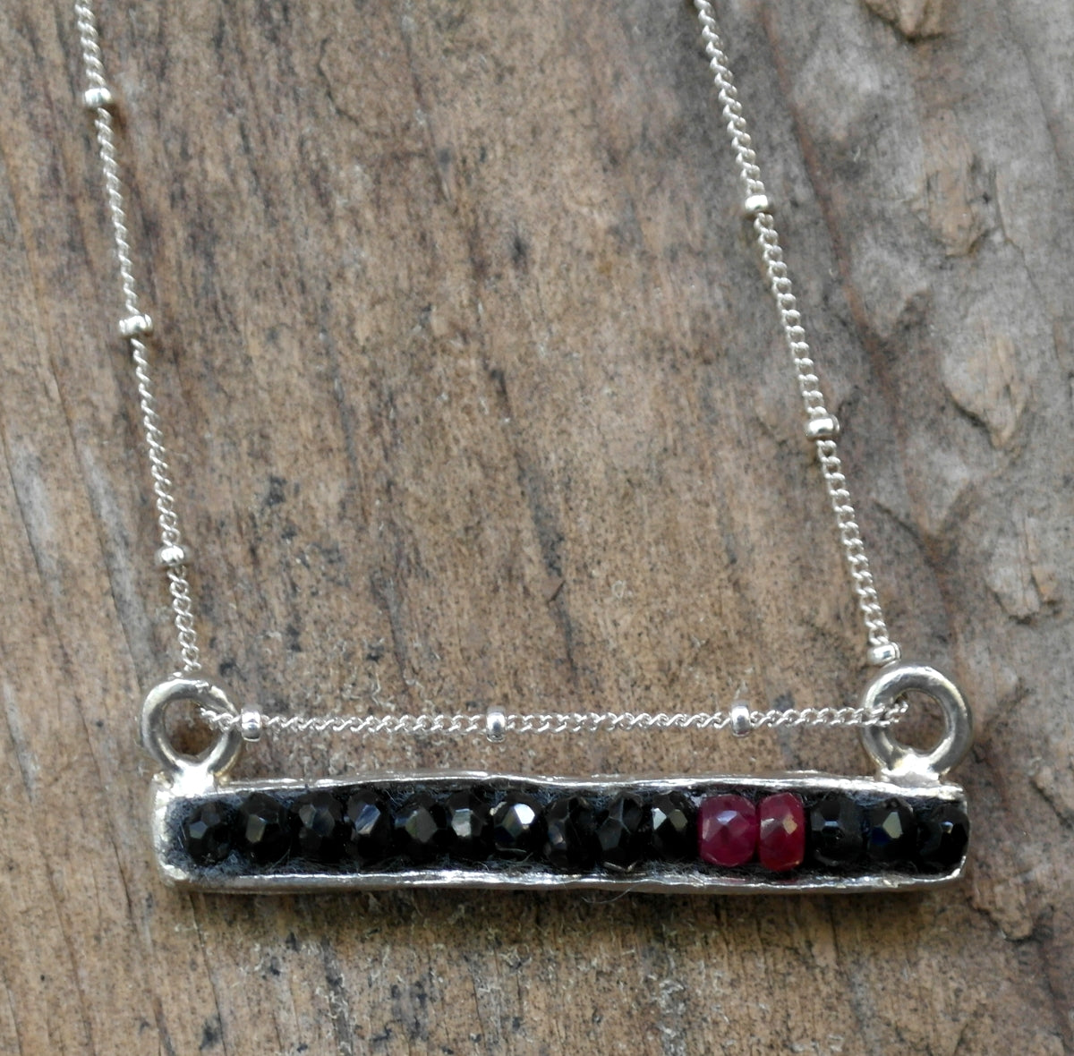 Black sapphire and ruby mosaic bar
